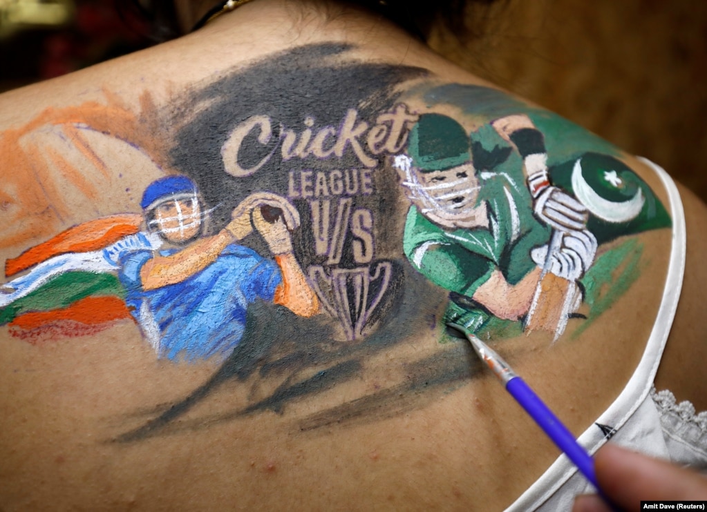 A cricket fan gets her back painted before the start of the first match between India and Pakistan in Twenty20 World Cup Super 12 in Dubai, in Ahmedabad, India.