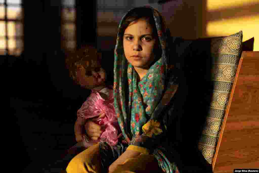 Samira, 9, poses for a photo in the living room at her orphanage in Kabul. Samira wants to be a doctor when she grows up. &quot;I want to serve my homeland and save others from disease, and I also want other girls to study so that they become a doctor like me in the future,&quot; she says.