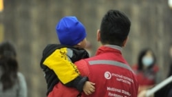 A Kyrgyz humanitarian worker at Bishkek airport holds a child who was among 79 children repatriated from Iraq in 2021. (file photo.)