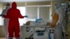 Medics wearing special suits to protect against the coronavirus treat a patient at an ICU at the Moscow City Clinical Hospital No. 52 in the Russian capital. “The situation in Moscow is developing according to the worst-case scenario,” Mayor Sergei Sobyanin said.