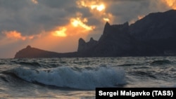 CRIMEA – A view of the Black Sea at sunset in the town of Sudak, 22Oct2021