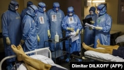 Medics wearing personal protective equipment work in the intensive care unit for COVID-19 patients in the Moscow Sklifosovsky emergency hospital on October 20.