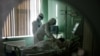 Medical specialists treat a patient suffering from COVID-19 at a hospital in the Russian city of Oryol.