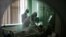 Medical specialists treat a patient suffering from COVID-19 at a hospital in the Russian city of Oryol.
