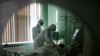 Russian medics treat a patient suffering from COVID-19 in the intensive care unit of a hospital in the Russian city of Orel. 