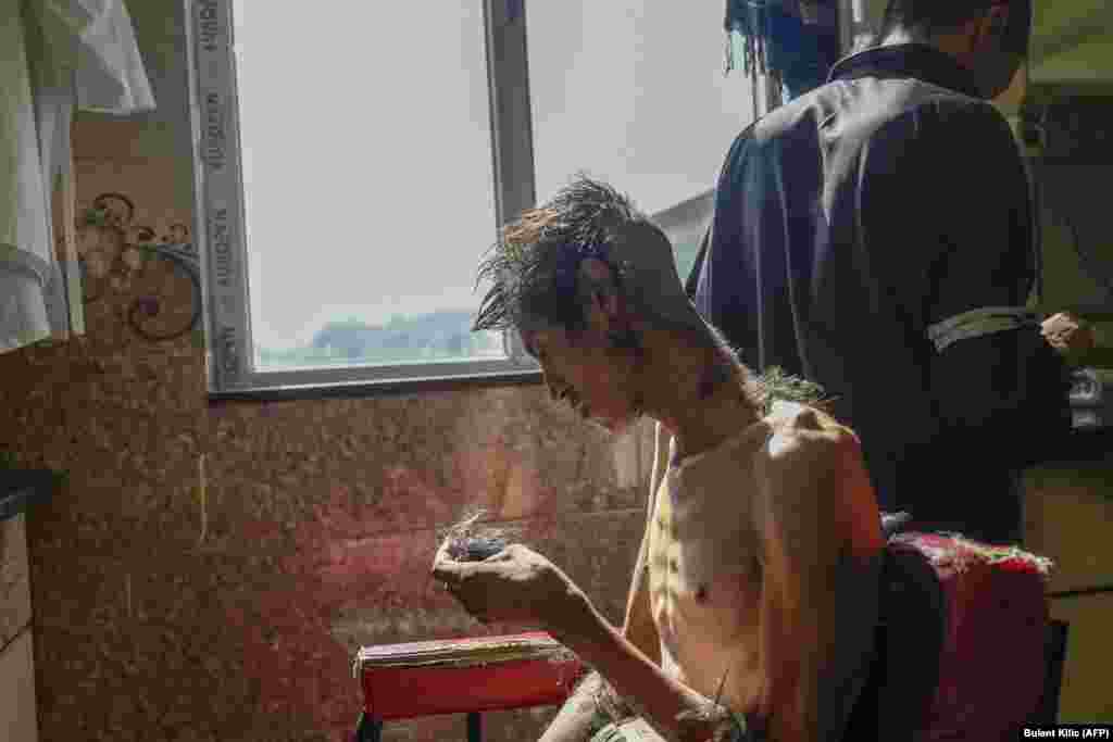 A patient has his head shaved in the detoxification ward of the Avicenna Medical Hospital for Drug Treatment in Kabul on October 16.