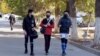 Turkmenistan. Young athletes after sports on the sidewalk talking to each other. Mask. Ashgabat, 2021.