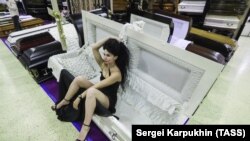 A model shows off a coffin during the exhibition.
