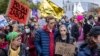 People in Warsaw take part in a protest rally on October 17 in solidarity with migrants who have been pushed back at Poland's border with Belarus.