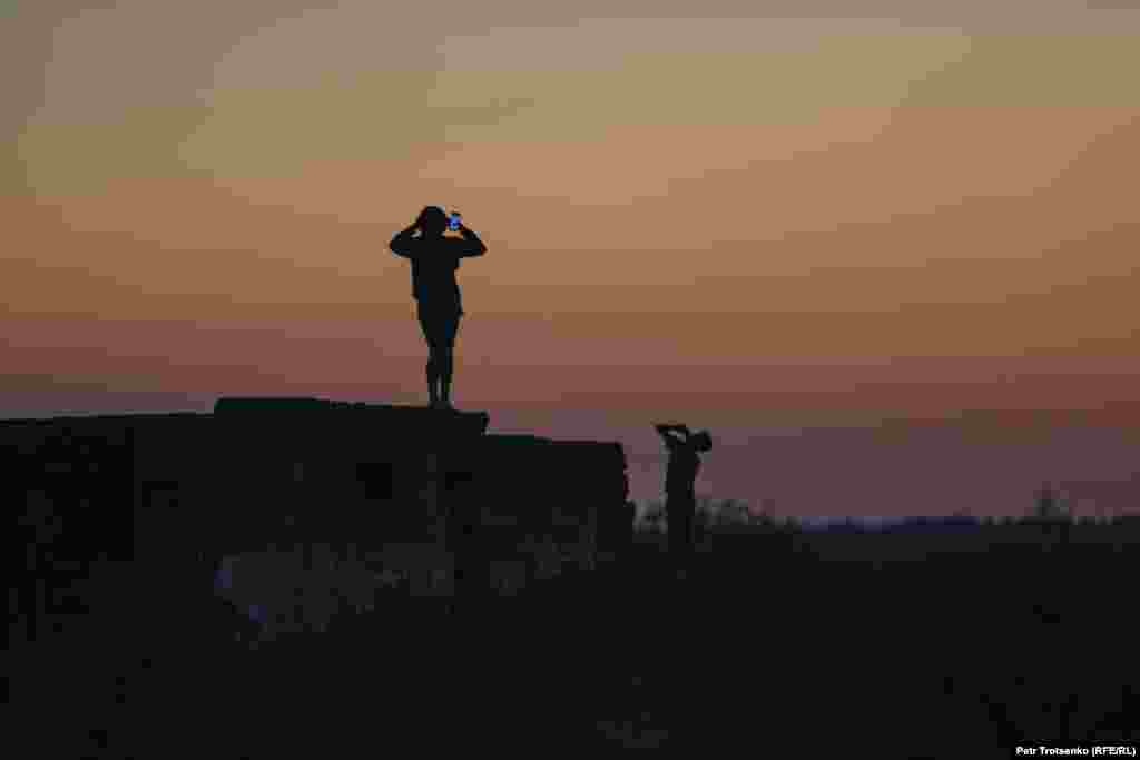 Teenagers try to catch a signal to go online in the village of Chebotarevo, in the West Kazakhstan region, on August 27.