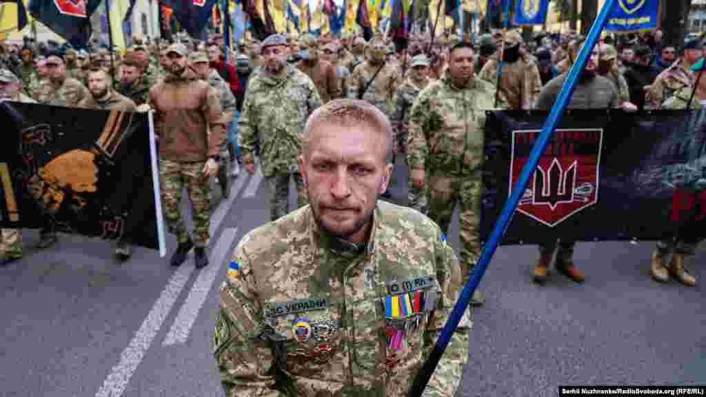 People march in the Ukrainian capital, Kyiv, on Defenders Day.&nbsp;