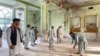 Afghan men inspect the damage inside a Shi'ite mosque in Kandahar on October 15 after a suicide bomb attack during Friday Prayers.
