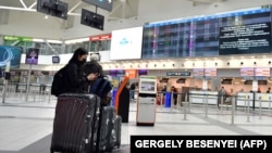 Utasok várakoznak a budapesti Liszt Ferenc Nemzetközi Repülőtér indulási oldalán 2020. március 23-án.
