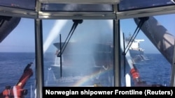 AT SEA -- A photo made available by the Norwegian shipowner Frontline of the crude oil tanker Front Altair during the firefighting of the fire onboard the ship in the Gulf of Oman, June 13, 2019