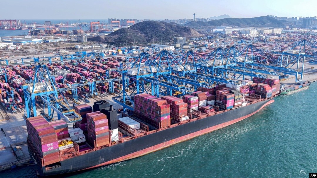Macarale descarcă containere de pe o navă într-un port din Qingdao, în provincia Shandong din estul Chinei, aprilie 2025.