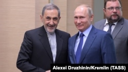 RUSSIA -- MOSCOW REGION, JULY 12, 2018: Ali Akbar Velayati, senior adviser to the Supreme Leader of Iran for international affairs, and Russia's President Vladimir Putin (L-R front) shake hands during a meeting at Novo-Ogaryovo residence. 