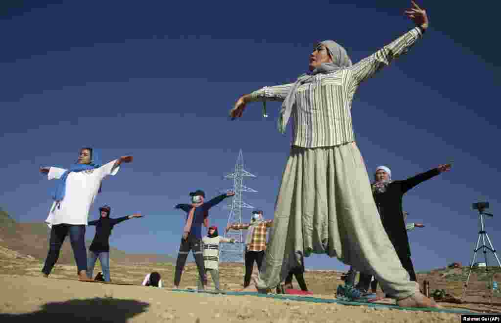 Afghan yoga enthusiasts perform to mark International Yoga Day on the outskirts of Kabul on June 21. (AP/Rahmat Gul)