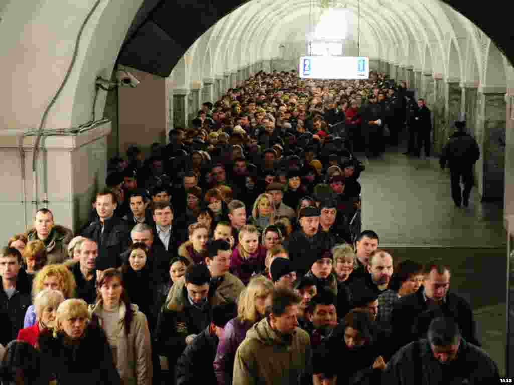 Passengers leave the Park Kultury subway station following the second blast.