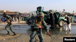 Afghan policemen inspect the site of a bomb explosion in Jalalabad on December 17.