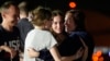 Alsu Kurmasheva (right) hugs her daughters, Bibi and Miriam, as her husband, Pavel Butorin, looks on at Joint Base Andrews outside of Washington, D.C., following her release as part of a 24-person prisoner swap between Russia and the United States, on August 1. 