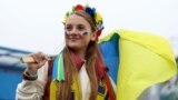 U.K. – Soccer Football - FIFA World Cup - UEFA Qualifiers - Final - Wales v Ukraine - Cardiff City Stadium, Cardiff, Wales, Britain - June 5, 2022A Ukraine fan holds a flag outside the stadium before the match