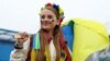 U.K. – Soccer Football - FIFA World Cup - UEFA Qualifiers - Final - Wales v Ukraine - Cardiff City Stadium, Cardiff, Wales, Britain - June 5, 2022A Ukraine fan holds a flag outside the stadium before the match