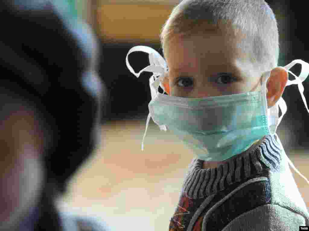 A boy in Chita, Russia, wears a mask as protection against swine flu.