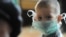 Russia -- A boy wears mask as swine flu spreads through the city of Chita, 29Oct2009