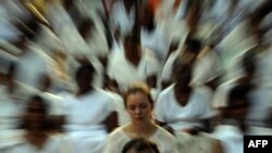 A foreign election observer, together with Sri Lankan citizens, meditate during a special gathering organized in Colombo for a peaceful election.