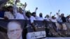 Supporters of former Prime Minister Nawaz Sharif shout slogans during a protest after an accountability court sentenced Nawaz Sharif to 10 years of imprisonment.