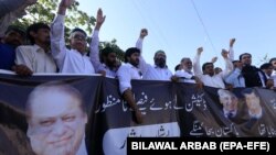 Supporters of former Prime Minister Nawaz Sharif shout slogans during a protest after an accountability court sentenced Nawaz Sharif to 10 years of imprisonment.