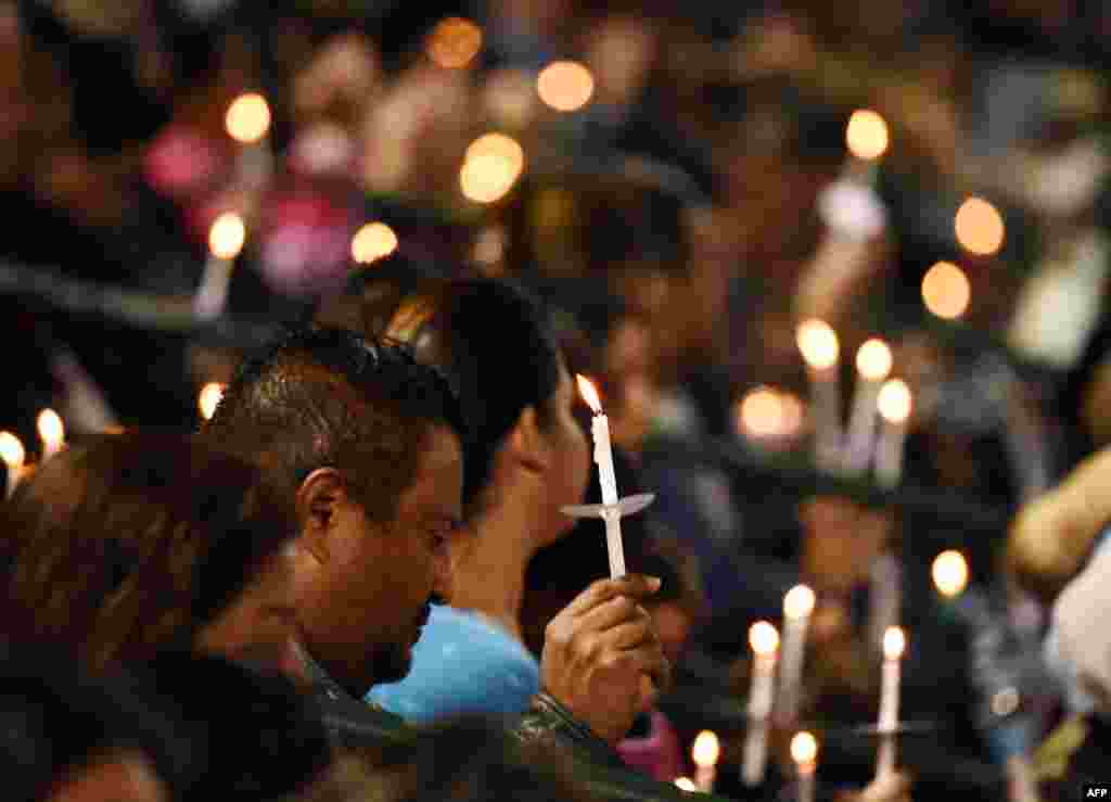 A candlelight vigil for the victims of a mass shooting in San Bernardino, California. A married couple, Syed Rizwan Farook and Tashfeen Malik, attacked a social services center on December 2, 2015, killing 14 people and seriously injuring 22 with automatic rifles, pistols, and pipe bombs. They were killed in a shootout with the police. The couple had sworn allegiance to the Islamic State militant group in social-media posts, officials said.