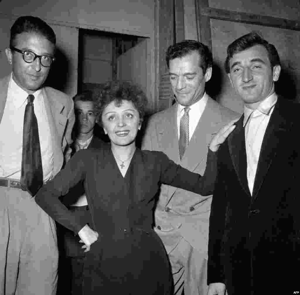 Piaf with French composer Michel Emer, American actor Eddie Constantine, and French singer of Armenian origin Charles Aznavour (left to right). (undated)