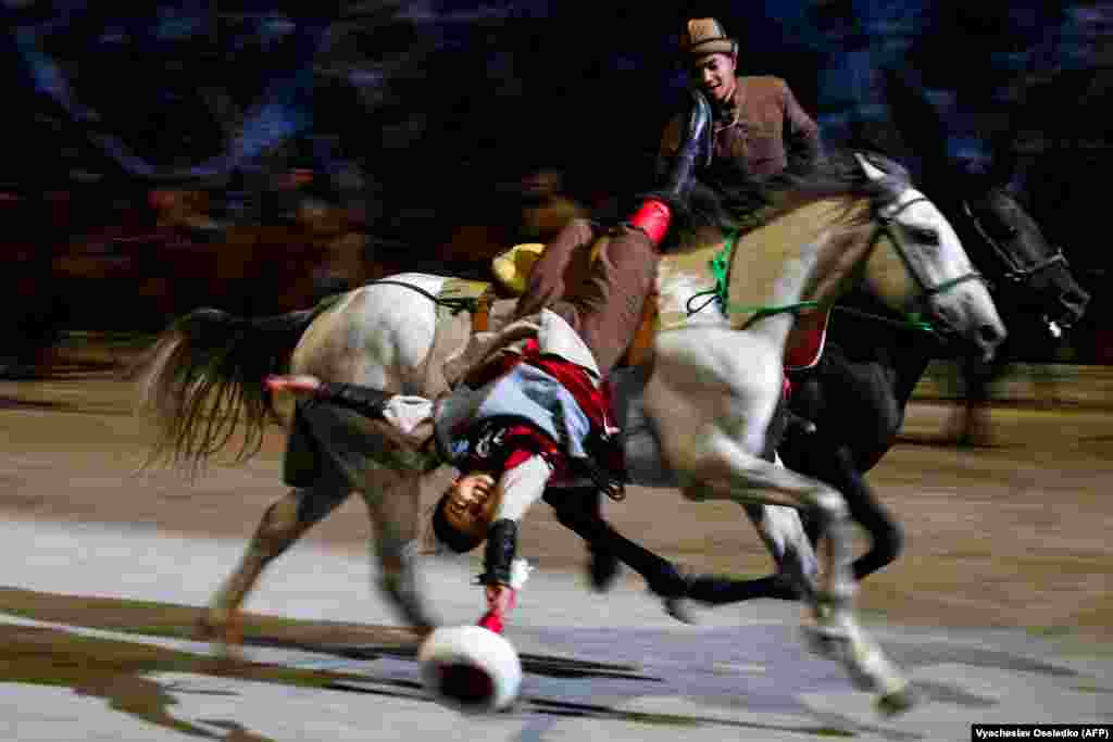 A trick rider performs during the opening ceremony.A reported 30,000 people attended the opening ceremony, with local media reporting sections of the new stadium, which is due to officially open in October, were still unfinished.