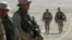 U.S. Defense Secretary James Mattis (second from right) when he was a Marine general, walking with troops in Afghanistan.