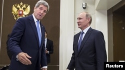 U.S. Secretary of State John Kerry (left) and Russian President Vladimir Putin greet each other before the start of nearly four hours of talks in Sochi.