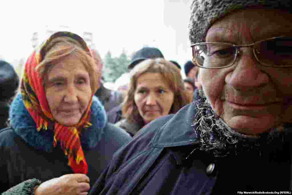 Pensioners patiently queue to register for World Food Program aid vouchers.