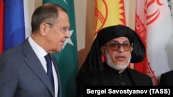 FILE: Russian Foreign Minister Sergei Lavrov (L), and her Mohammad Abbas Stanikzai, the head of the Taliban office in Doha.