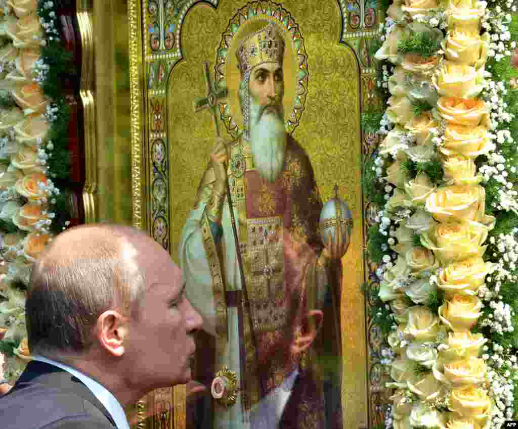 Russian President Vladimir Putin kisses an icon during a service and ceremony in Kyiv on July 27 to celebrate the 1,025th anniversary of Christianity in Ukraine, Belarus, and Russia.