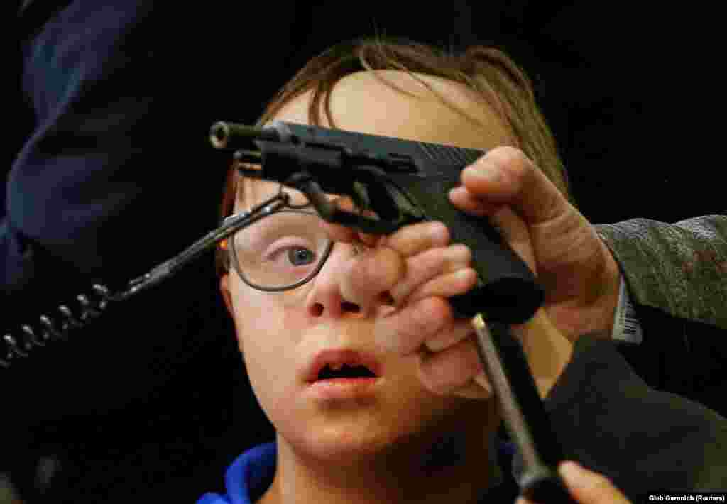 A visitor attends an annual exhibition of weaponry and military equipment in Kyiv. (Reuters/Gleb Garanich)