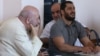 Armenia - Father Anton Totonjian (L) and Artur Vartanian (R) stand trial on coup charges in Yerevan, 28Jul2017.