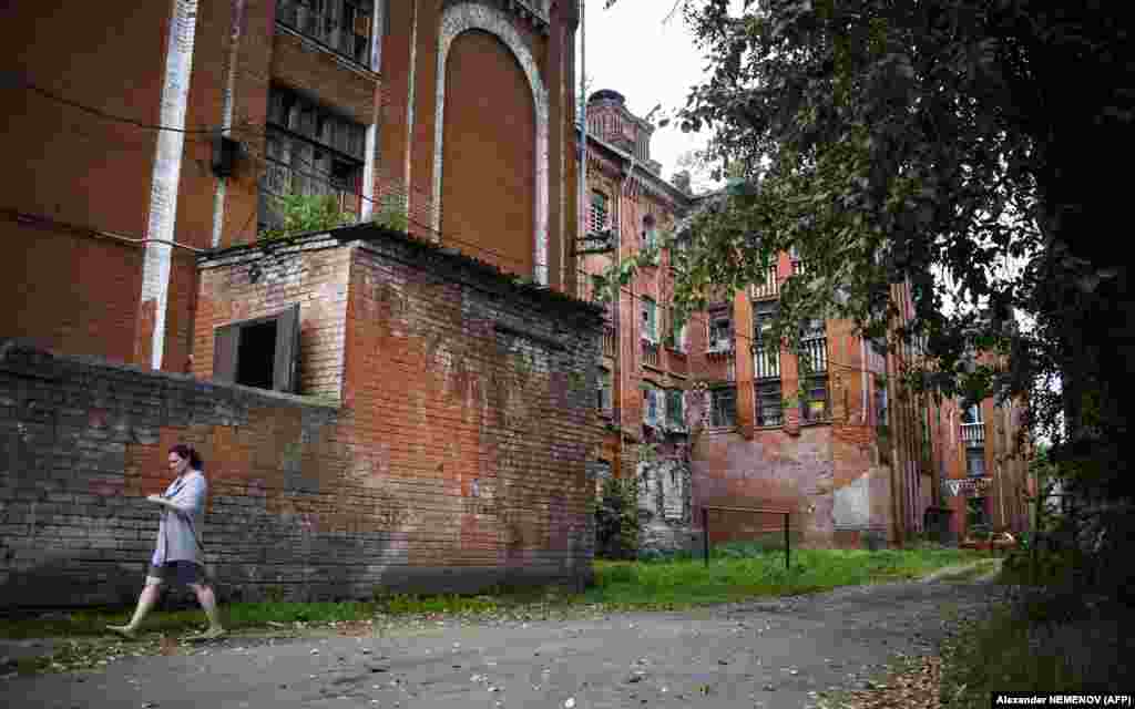 A woman walks past one of the dormitory buildings.&nbsp;An ambitious plan to regenerate the area over a 10-year-period had been proposed, but it was never implemented because it would have cost twice as much as Tver&#39;s entire annual budget.