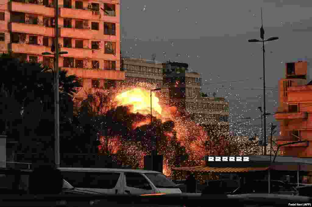 An explosion rocks a building in Beirut, Lebanon, amid Israeli air strikes on the city on March 18