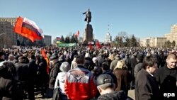 Pro-Russian demonstrators take part in a rally in front of a statue of Lenin in Kharkiv on March 8.