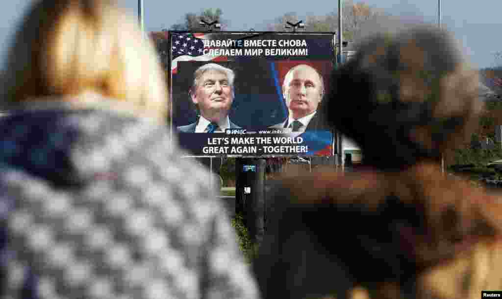 A billboard showing pictures of U.S. President-elect Donald Trump and Russian President Vladimir Putin is seen through pedestrians in Danilovgrad, Montenegro. (Reuters/Stevo Vasiljevic)