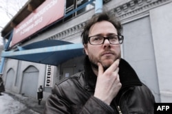 Swiss director Milo Rau stands outside the Sakharov Center.