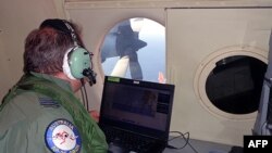 A crew member of an Australian maritime patrol aircraft involved in the search operation for Malaysian Airlines Flight MH370