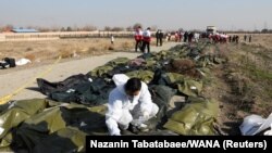 Passengers' bodies in plastic bags are pictured at the site where the Ukraine International Airlines plane crashed after take-off from Iran's Imam Khomeini airport, on the outskirts of Tehran, Iran January 8, 2020.