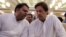 Fawad Chaudhry (left) speaks to Imran Khan in 2018.