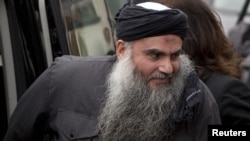 Radical Muslim cleric Abu Qatada arriving at his home in London after being released on bail in November 2012.